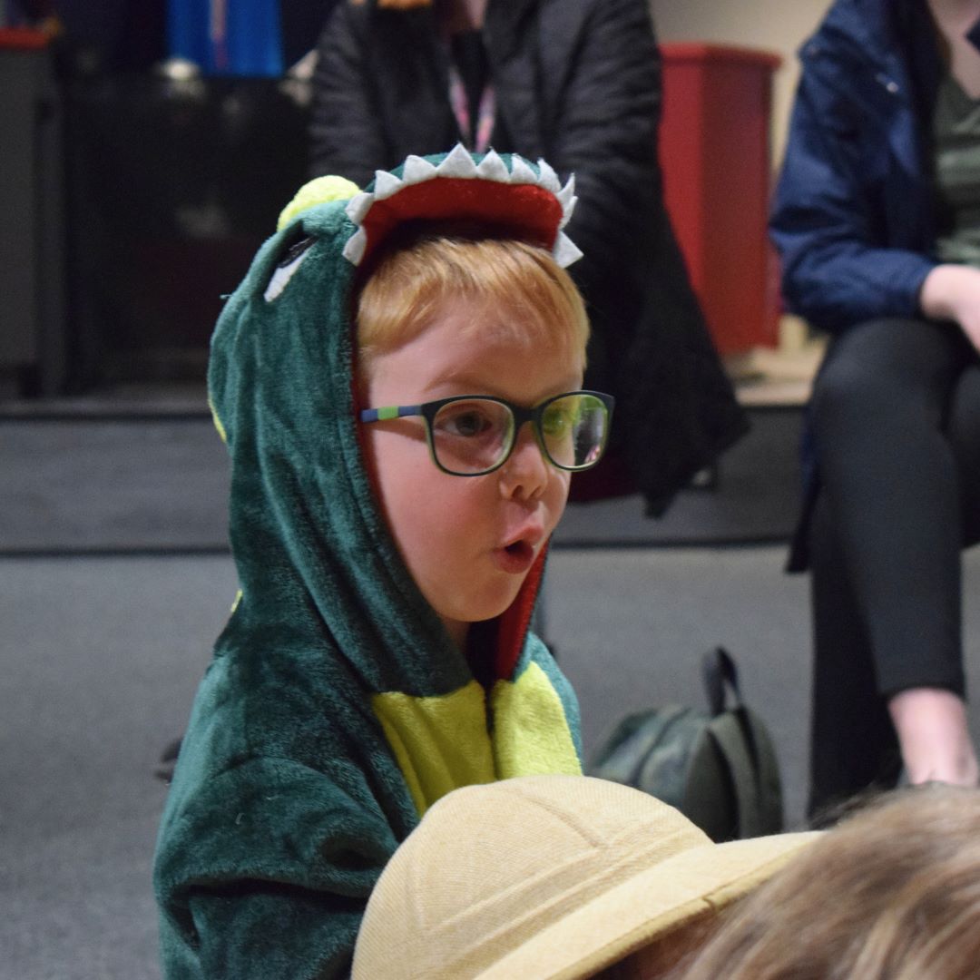 Child in dinosaur costume